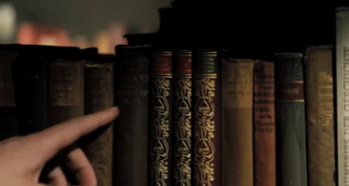 Gif of finger touching the spines of books on a shelf. Used in "How to find books using Biblio's Want List"
